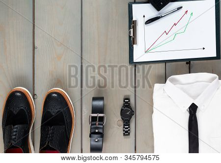 Businessman, Work Outfit On Grey Wooden Background.
