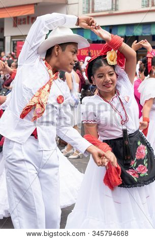 XALAPA, VERACRUZ, MEXICO- NOVEMBER 24, 2019: Young couple dancing and dressed with traditional cloth