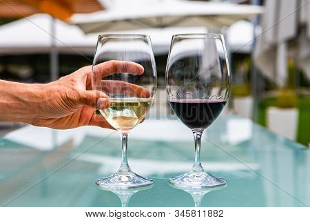 Man Hand On White Wine Glass, Pair Of White And Red Wines Glasses Close Up Selective Focus, Restaura