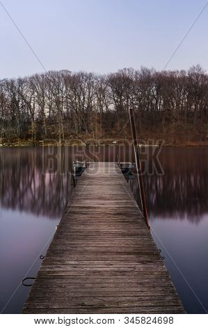 A Dock On A Calm Pond In Beautiful Magenta Night Light