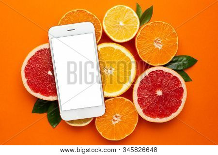 Mobile Phone And Citruses On An Orange Background, Fruit Flatlay, Summer Minimal Compositon With Gra
