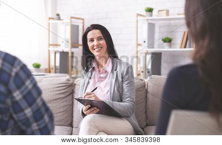 Effective Marital Therapy. Friendly Family Psychologist Giving Advice To Spouses, Free Space