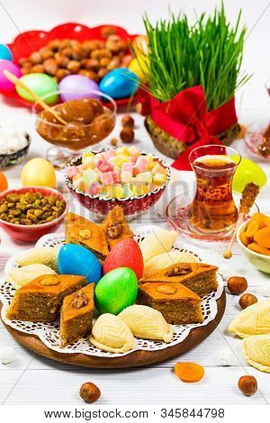 Novruz Ramadan In Azerbaijan. Colored Eggs, Wheat Springs For Easter And Traditional Sweets. Selecti
