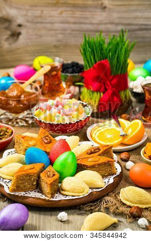 Novruz Ramadan In Azerbaijan. Colored Eggs, Wheat Springs For Easter And Traditional Sweets. Selecti