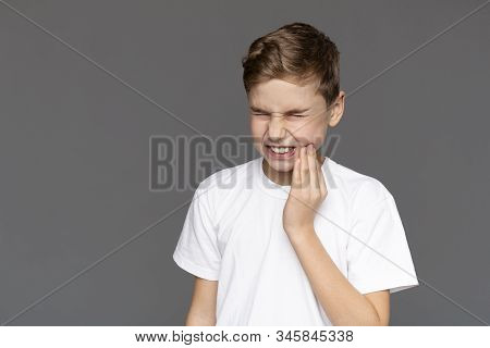Teen Boy With Acute Toothache, Grey Background With Free Space