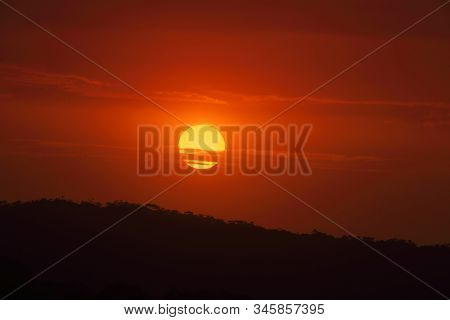 Large Golden Sun Setting Amidst Cloud And Smoke Haze From Bushfires