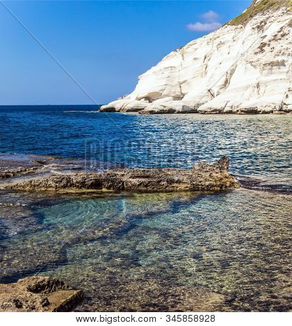 The border between Israel and Lebanon. The color of sea water from azure to dark blue. Rocky bay near chalk mountain Rosh a Nikra in northern Israel. The concept of eco and photo tourism