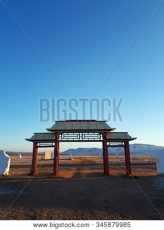 Wooden Temple Gate With White Fence Yelliw Roof Clear Blue Sky