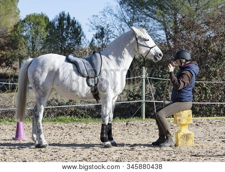 Riding Girl Are Training Her White  Horse