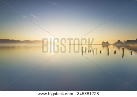 Wooden Pier Or Jetty Remains And Lake At Sunrise. Long Exposure. Torre Del Lago Puccini, Versilia, M