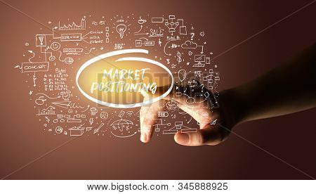 Hand touching MARKET POSITIONING inscription, hand drawn icons around, business plan concept