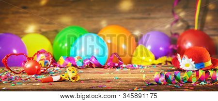 Colorful carnival or birthday background with party hat, streamers and confetti and balloons 
