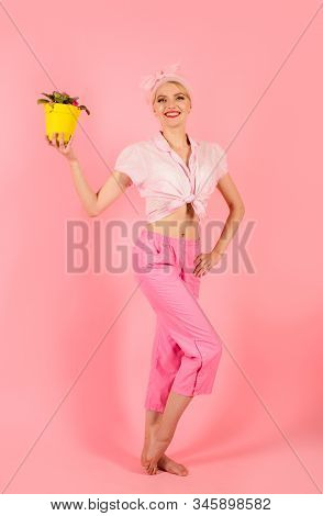 Smiling Girl Hold Flowers In Pot. Woman Take Care Of Flowers. Girl With Flower Pot. Violet Flowers. 