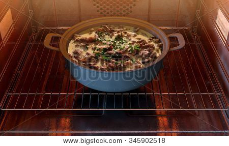 A Close View Of A Pot Of Beef Stroganoff Inside A Hot Household Oven   - 3d Render