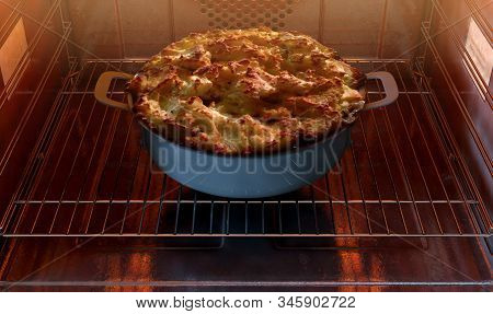 A Close View Of A Cottage Pie In A Pot Inside A Hot Household Oven   - 3d Render