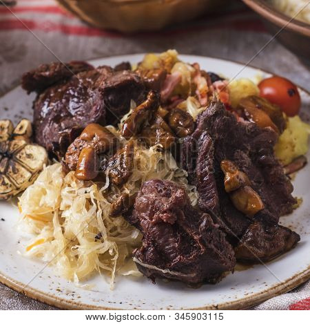 Beef Cheeks With Potato, Sauerkraut And Mushrooms. Closeup