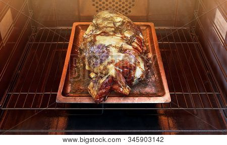 A Close View Of A Roast Lamb On A Baking Tray Inside A Hot Operational Household Oven - 3d Render