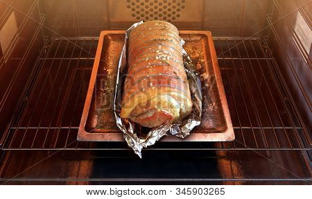 A Close View Of A Roast Pork On A Baking Tray Inside A Hot Operational Household Oven - 3d Render