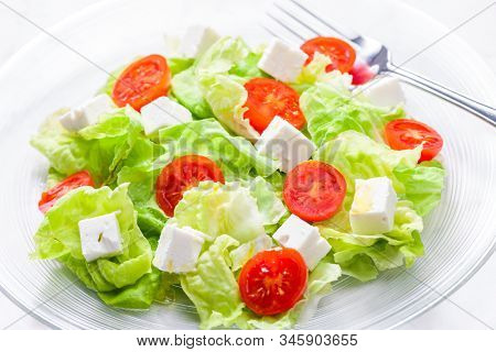 salad with fresh vegetables, feta cheese and tomatoes