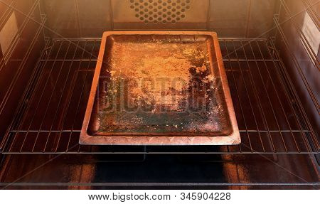 A Close View Inside A Hot Operational Household Oven With An Empty Tarnished Baking Tray - 3d Render
