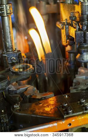 Glassworks. Glass Industry. Making Glass Bottles. Burning Blank Glass Bottle In The Machine