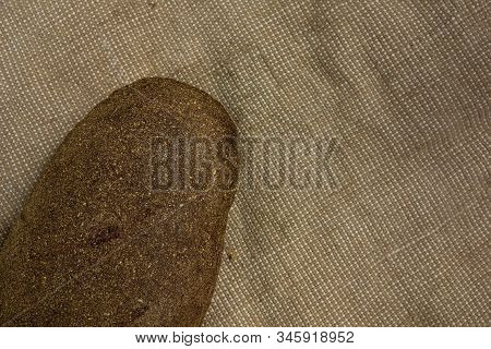 Brown Bread On Bagging Fabric. Closeup View Of Whole Wheat Rye Bread Unsliced Loaf Of Fresh Homemade