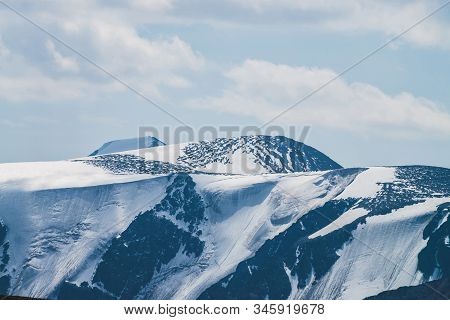 Atmospheric Minimalist Alpine Landscape With Massive Hanging Glacier On Snowy Mountain Peak. Big Bal