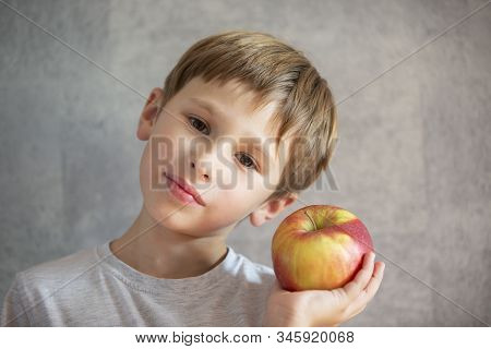 Child With Fruit. Funny Boy With Huge Apples