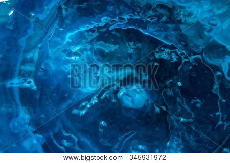 Textured Blue Substance Background. Foam Consistence Backdrop Closeup View Of Gel, Mousse Or Water. 