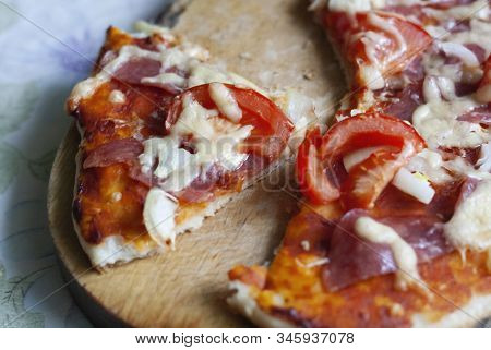 Homemade Pizza With Tomatoes, Sausage, Onion And Cheese, Cut