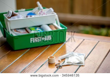 First Aid Kit On The Table In The Garden, Green Box