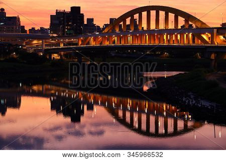 Songshan District Sunset Cityscape In Taipei. River Skyline Reflection.