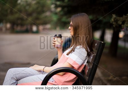 Git In Sunglasses Sit On Bench And Drink Coffee