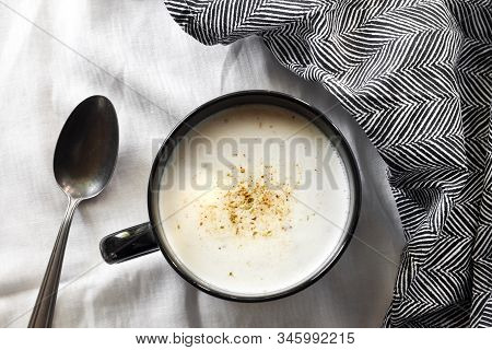 Cauliflower Soup (creme Du Barry) In Black Bowl On White Background With Black And White Cloth. Fren