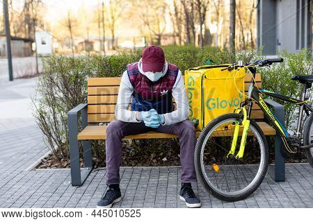 Kiev, Ukraine - April 28, 2021: Glovo Bike Courier On The Street. Delivery Boy Of Glovo Delivery Ser