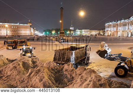 Snow Removal Equipment Working At Palace Square At Night After Heavy Snowfall. Snow Cyclone Or Blizz