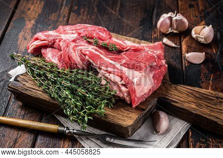 Raw Boneless Lamb Meat, Raw Neck Meat On Wooden Board. Black Background. Top View