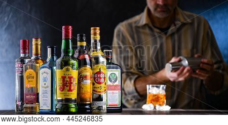 Poznan, Pol - Dec 28, 2021: Bottles Of Assorted Global Hard  Liquor Brands And A Bartender Preparing