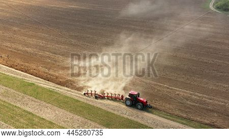 4k Aerial Flat View Tractor Plowing Field In Spring Season. Beginning Of Agricultural Spring Season.