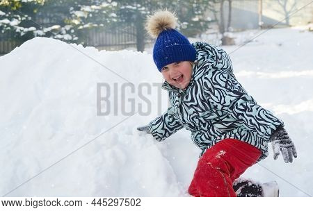 Caucasian Child In Winter Clothing Playing Outdoors
