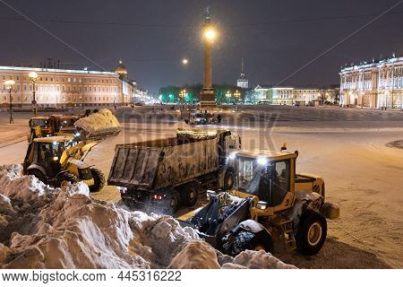 Snow Removal Equipment Working At Palace Square At Night After Heavy Snowfall. Snow Cyclone Or Blizz