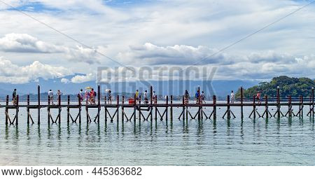 Kota Kinabalu, Malysia - May 21, 2008: People Walking On  The Wooden Wharf On The Bay