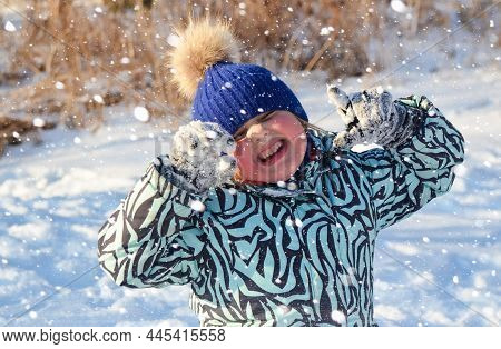 Caucasian Child In Winter Clothing Playing Outdoors