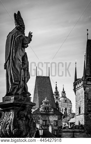 Statue of Adalbert of Prague on Charles Bridge and The Old Town of Prague, Czech Republic. Atrwork: Designed by Michael and Ferdinand Brokoff in 1709