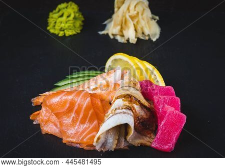 Asian Food Assortment. Various Sushi Rolls Placed On Ceramic Plates. Kimchi And Goma Wakame Salads. 