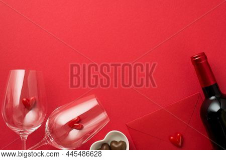 Top View Photo Of Valentine's Day Decorations Small Hearts In Two Wineglasses Closed Red Envelope He