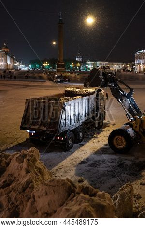 Snow Removal Equipment Working At Palace Square At Night After Heavy Snowfall. Snow Cyclone Or Blizz