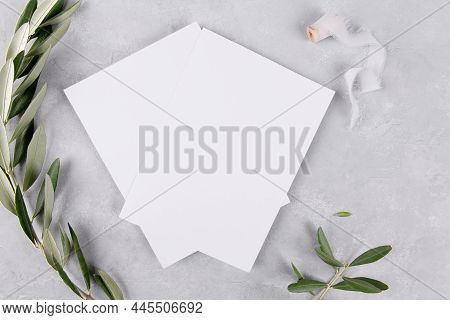 Two Blank Wedding Invitation Stationery Card Mockup On Grey Stone Table Background With Olive Branch