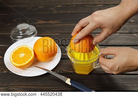 Hands Squeeze Fresh Juice From Oranges, Juicer For Manual Fruit Pressure, Healthy Eating