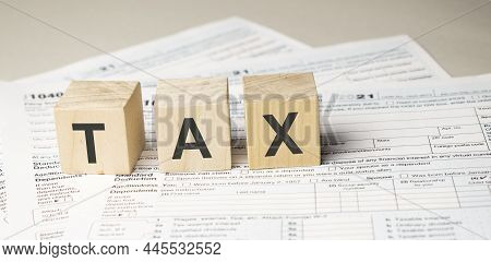 Word Tax Written On Wooden Cubes. Tax Concept
